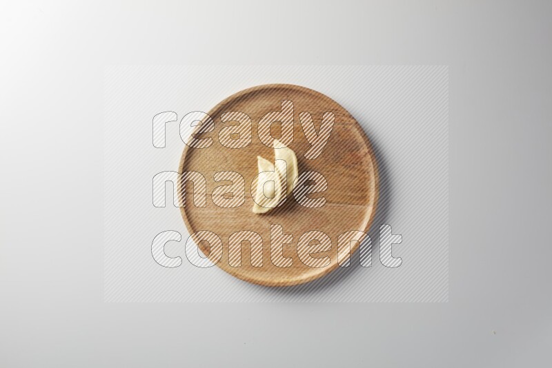 Two Sambosas on a wooden round plate on a white background