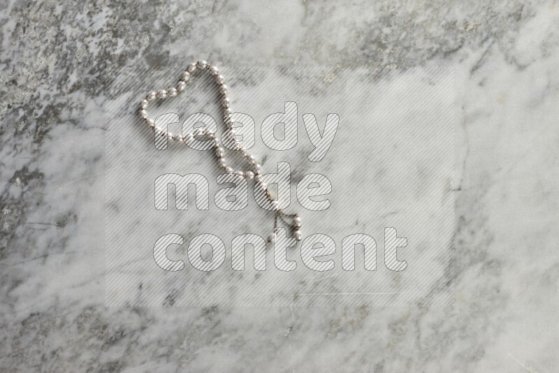A prayer beads placed on grey marble background