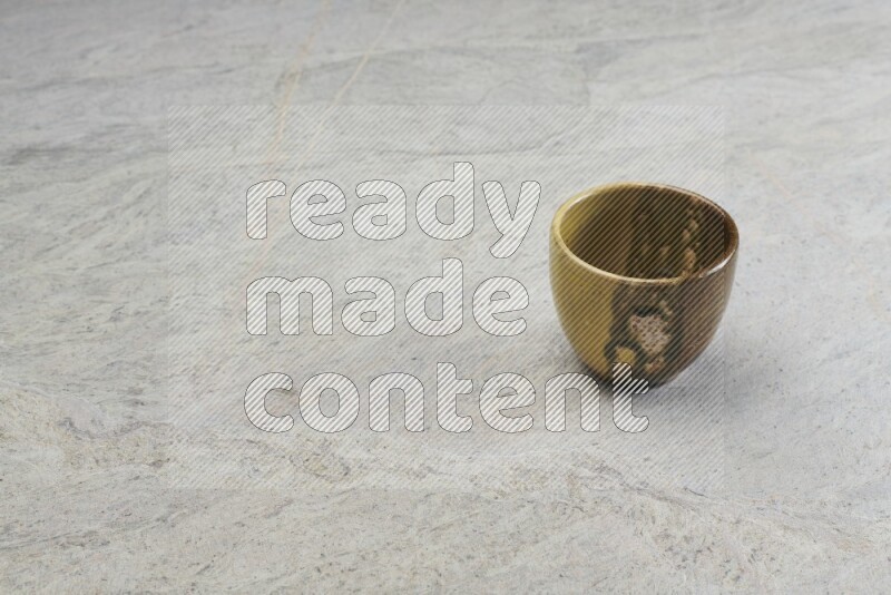 A multicolored pottery bowl on grey marble background