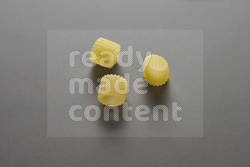 Big rings pasta on grey background