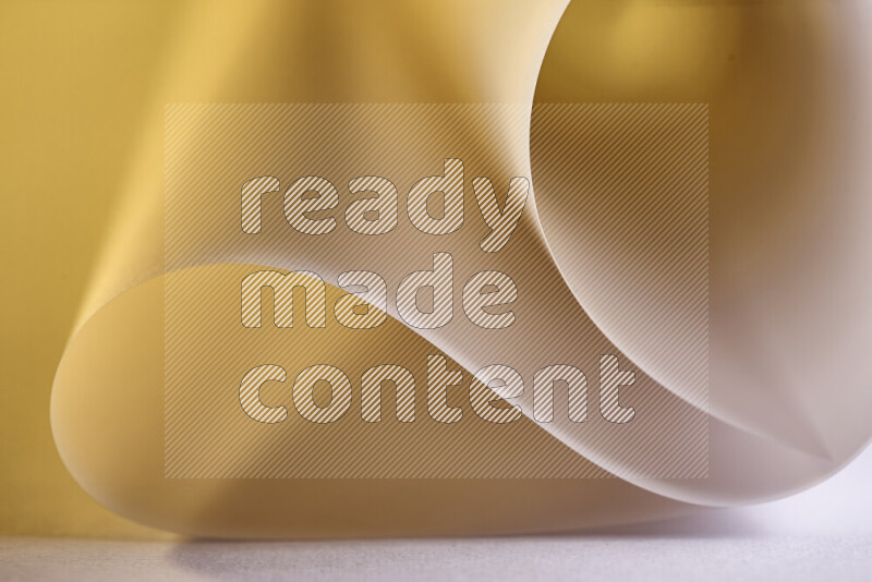 An abstract art piece displaying smooth curves in gold gradients created by colored light