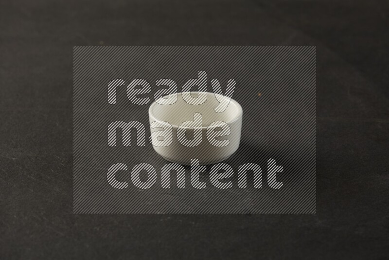 white ceramic round sauce bowl on grey textured countertop