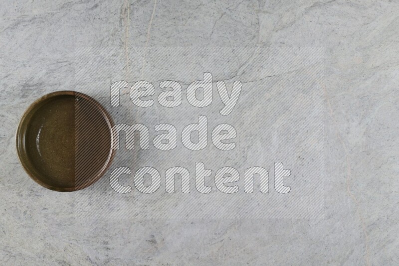 A multicolored pottery oven bowl on grey marble background