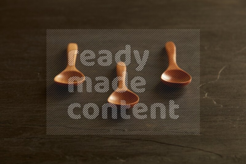 wooden spoon on black slate background