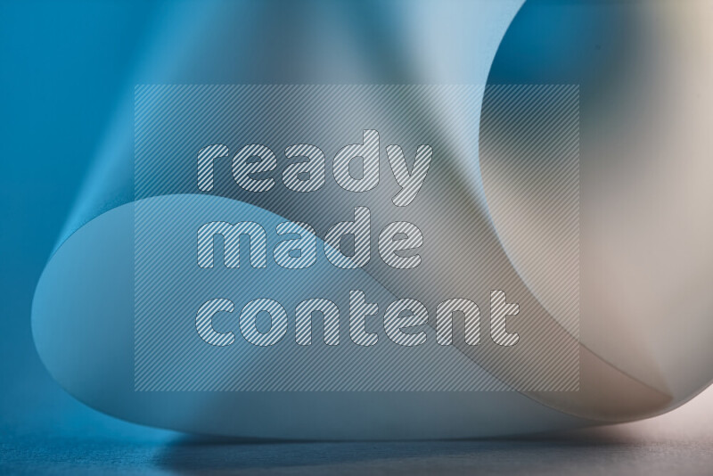 An abstract art piece displaying smooth curves in blue and gold gradients created by colored light