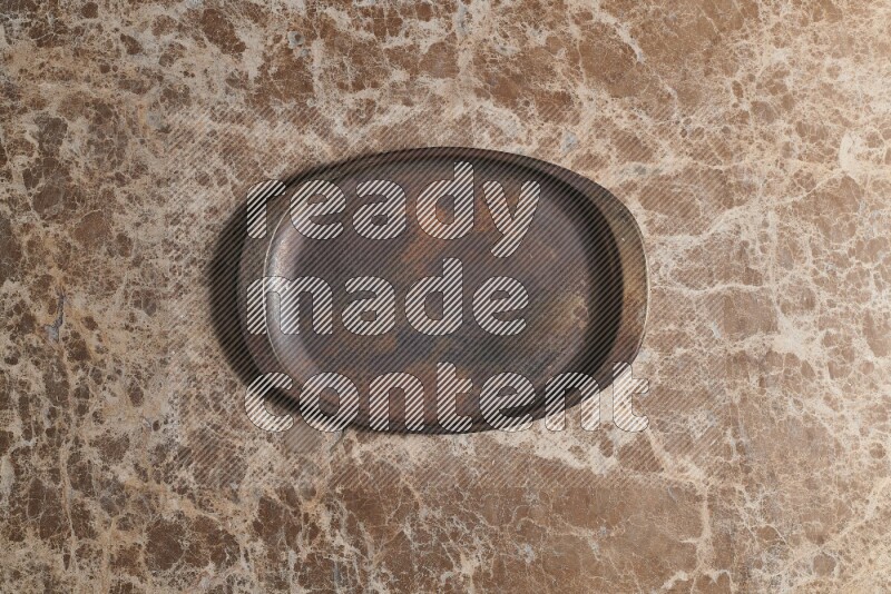 A vintage metal tray on beige marble background