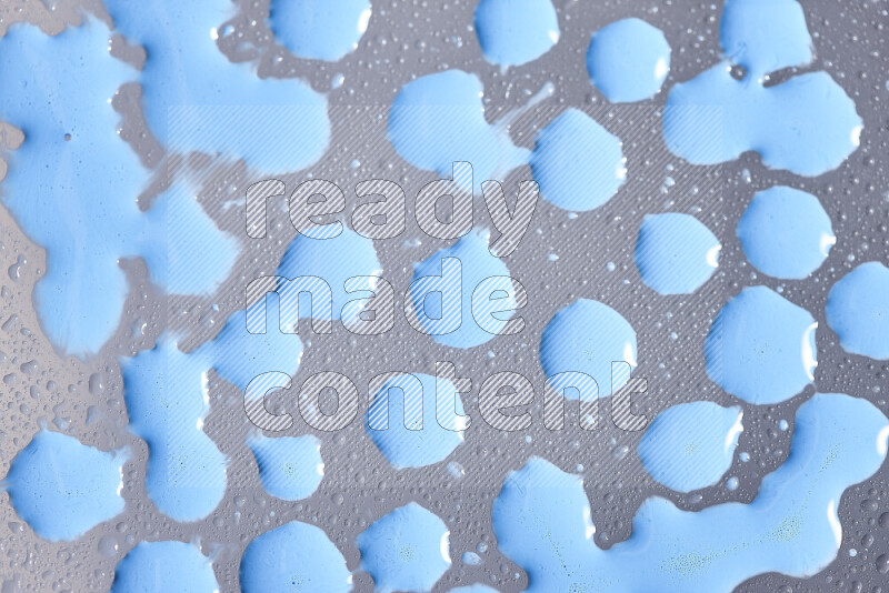 Close-ups of abstract blue paint droplets on the surface