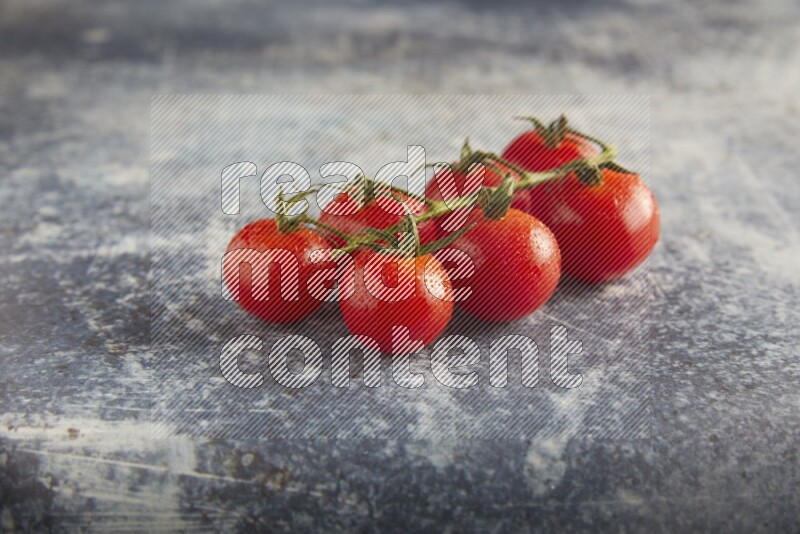 Red cherry tomato vein on a textured rusty blue background 45 degree