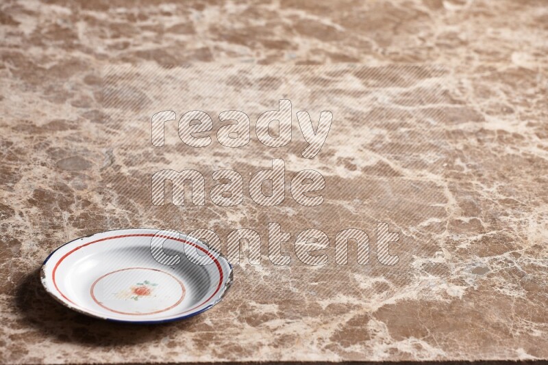 A vintage metal plate on beige marble background