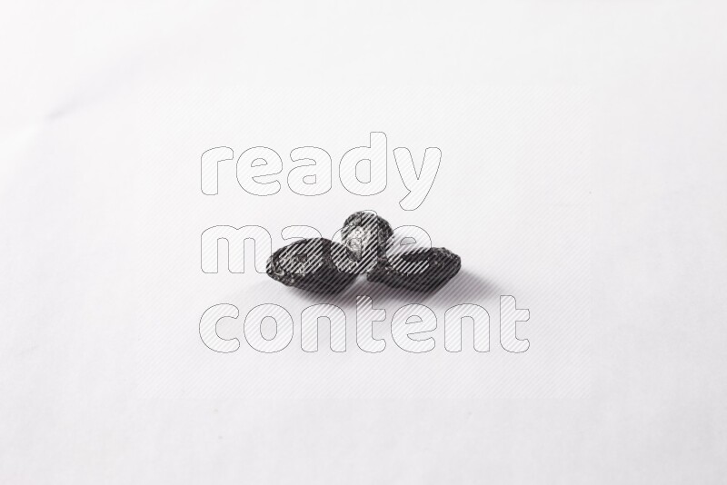 Dried plums on white background
