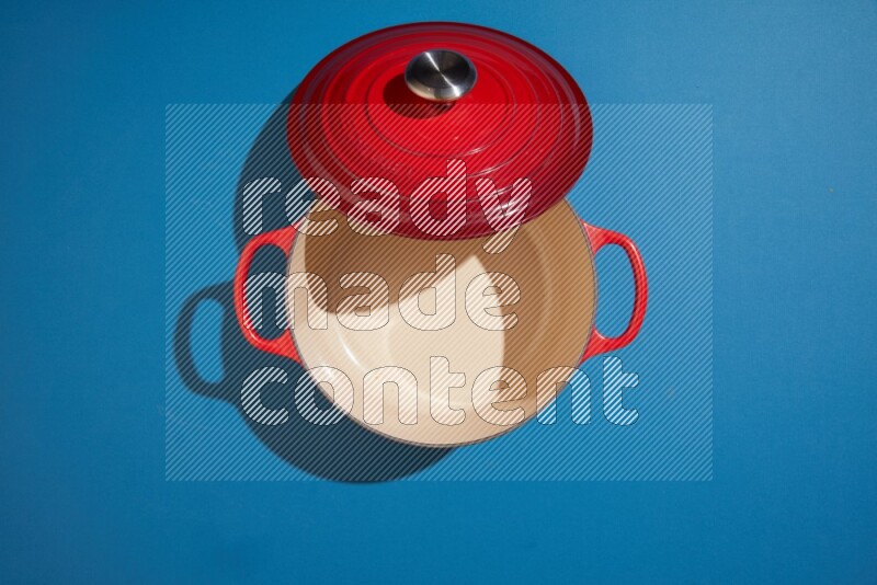 red and white pan and pot on blue background