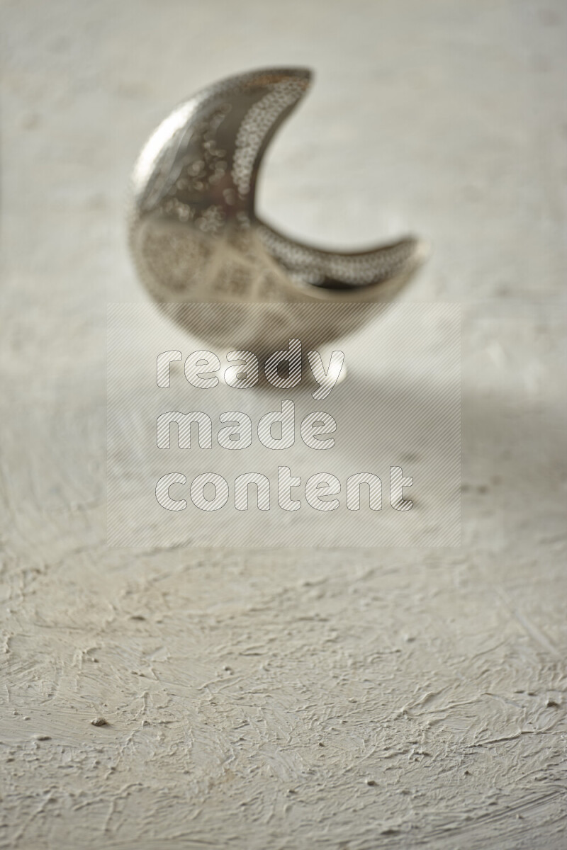 A lantern placed on a textured white background