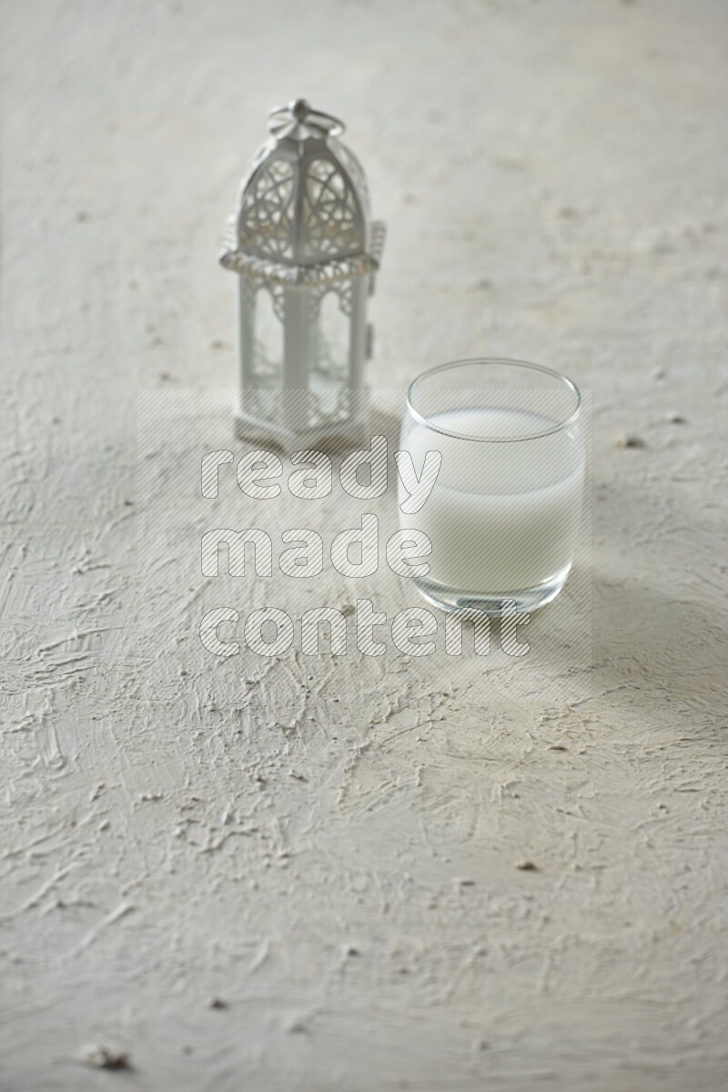 A white lantern with different drinks, dates, nuts, prayer beads and quran on white background