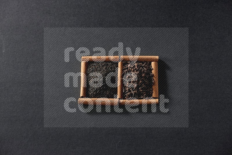 2 squares of cinnamon sticks full of tea and cloves on black flooring