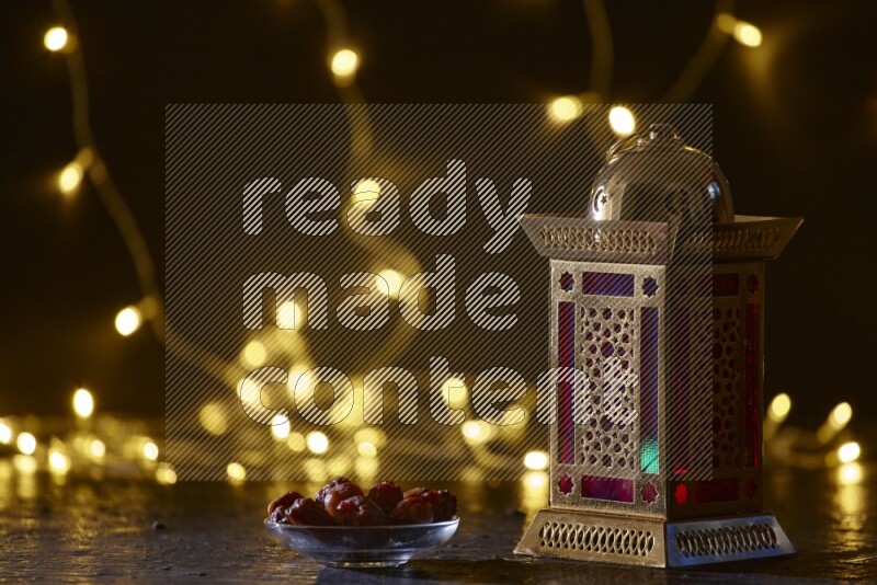 A traditional ramadan lantern surrounded by glowing fairy lights in a dark setup
