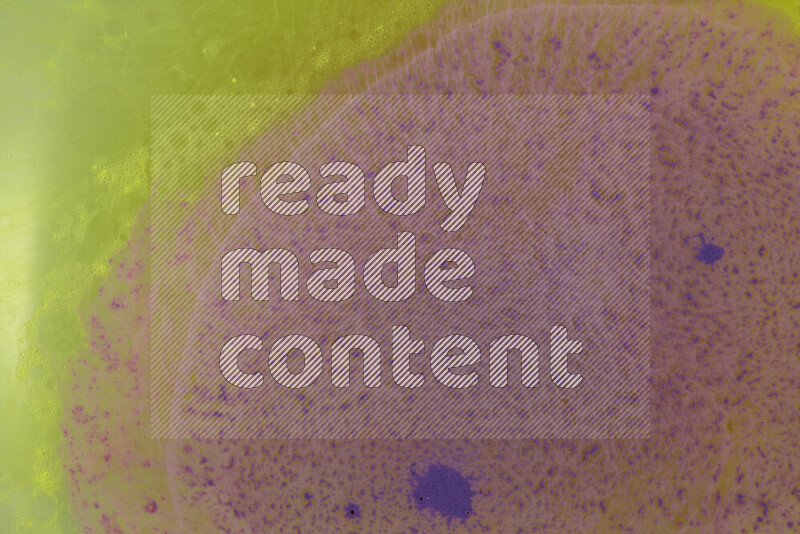 The image captures a dramatic splatter of purple paint over a yellow backdrop