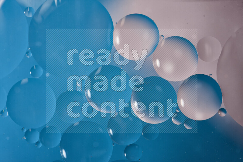 Close-ups of abstract oil bubbles on water surface in shades of white and blue