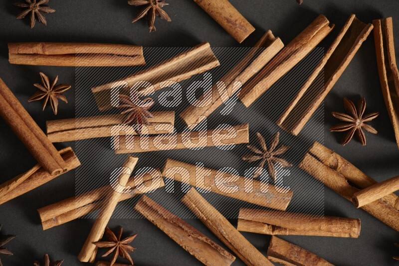 Cinnamon sticks and star anise on black background