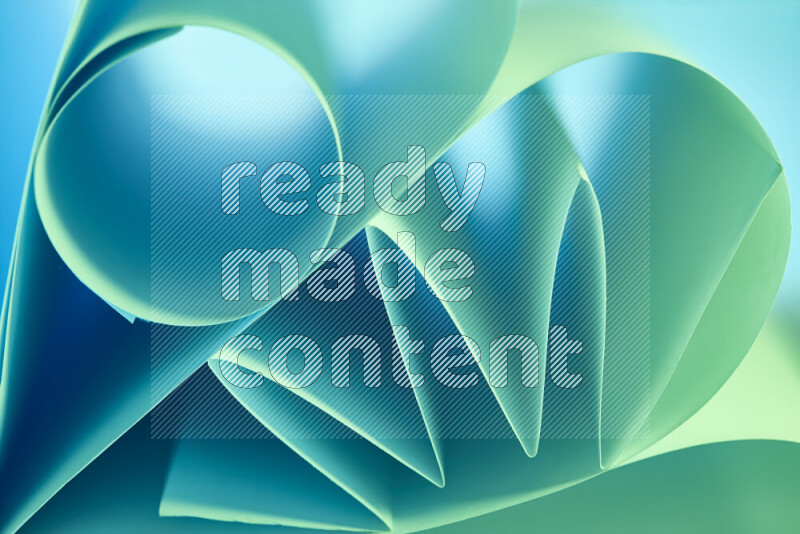 An artistic display of paper folds creating a harmonious blend of geometric shapes, highlighted by soft lighting in green and blue tones