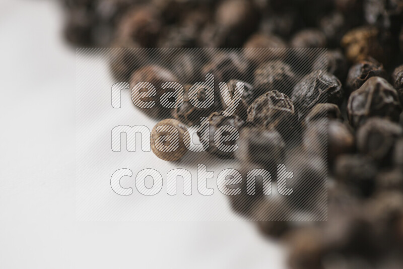 Black pepper beads on white background