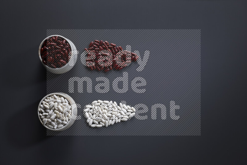 Legumes in pottery bowls on grey background