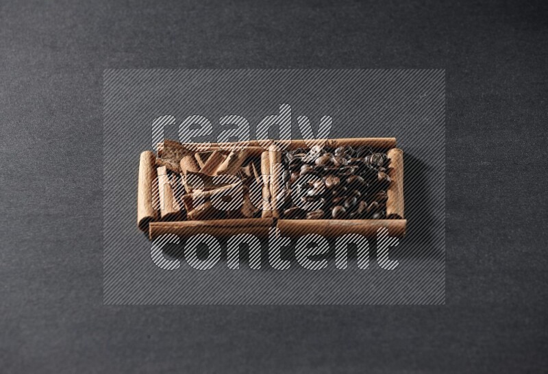 2 squares of cinnamon sticks full of coffee beans and cinnamon on black flooring