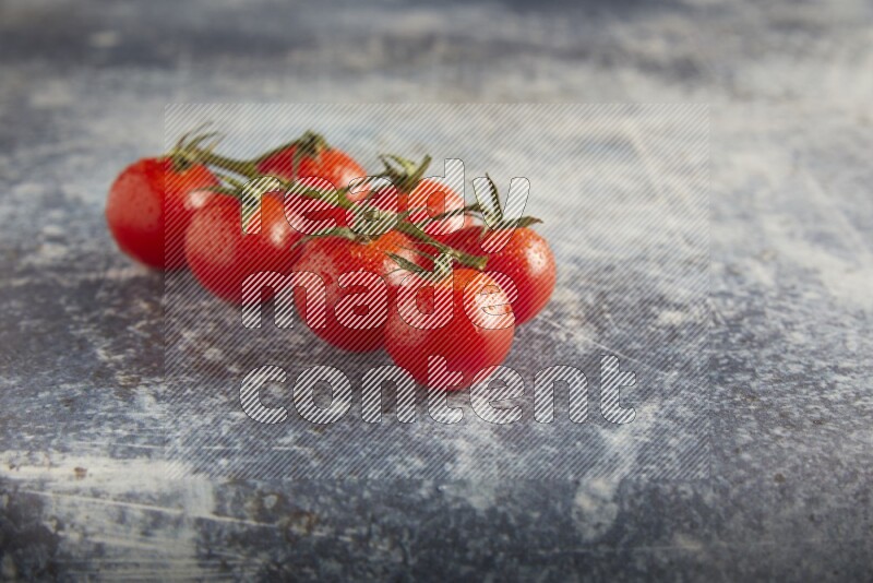 Red cherry tomato vein on a textured rusty blue background 45 degree
