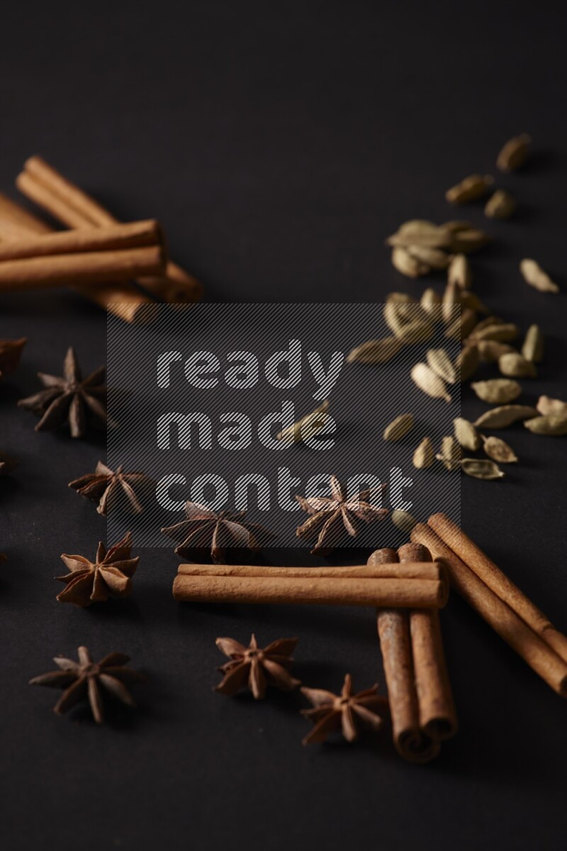 Cinnamon Sticks, Cardamom and star anise on a black background