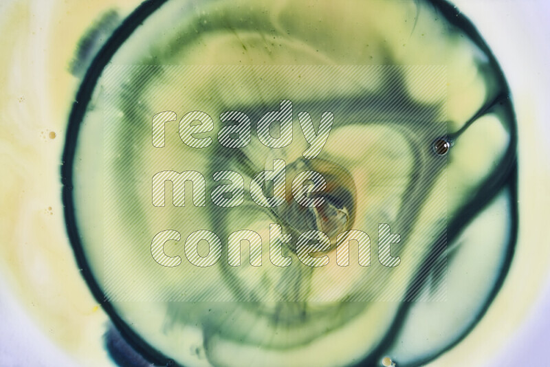 A close-up of abstract swirling patterns in yellow and green