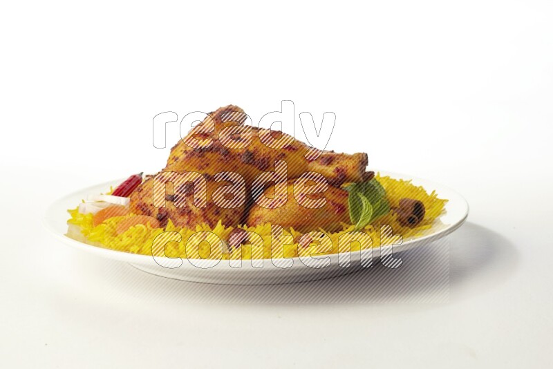 yellow basmati Rice with kabsa chicken pieces on a white rounded plate direct on white background
