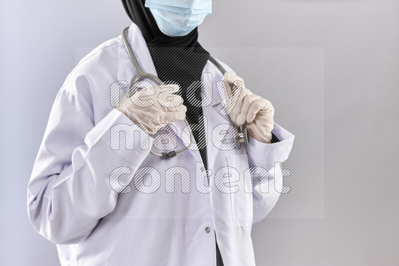 Female doctor wearing an abaya and medical attire in different positions