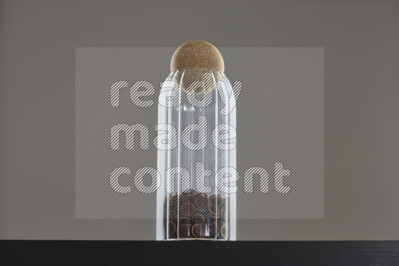 Buttons in a glass jar on black background