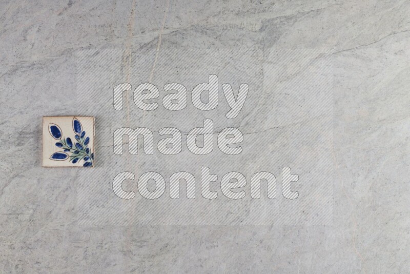 A decorative pottery coaster on grey marble background