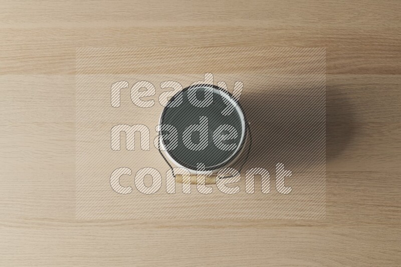 A vintage milk can on light wooden background