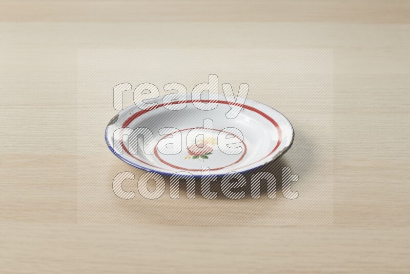 A vintage metal plate on light wooden background