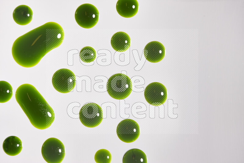 Close-ups of abstract green paint droplets on the surface