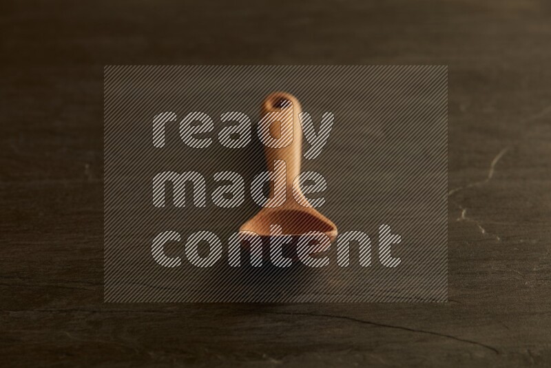 wooden spoon on black slate background