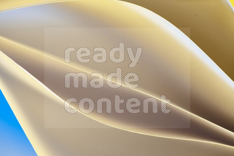 This image showcases an abstract paper art composition with paper curves in gold gradients created by colored light