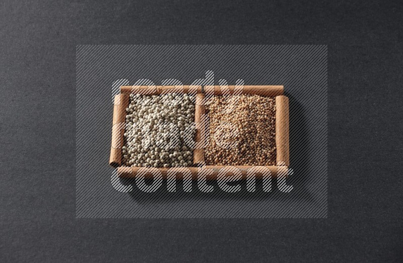 2 squares of cinnamon sticks full of mustard seeds and white peppers on black flooring