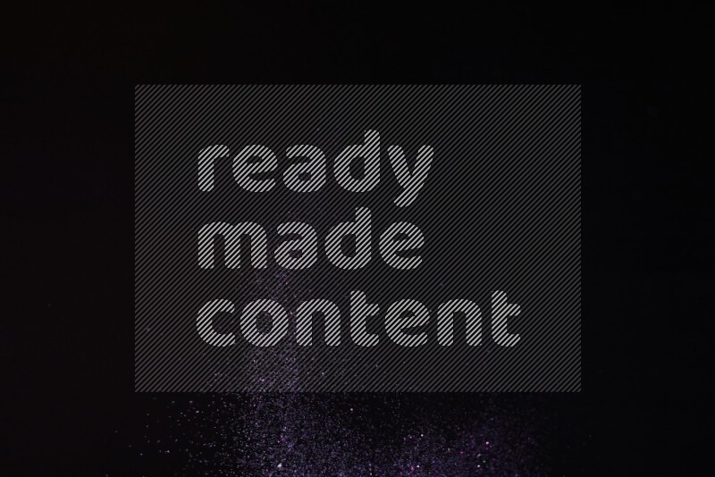Purple glitter powder isolated on black background