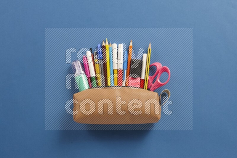 Different school supplies on blue background