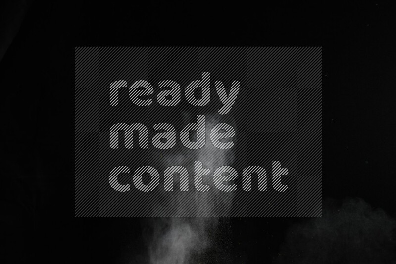 A side view of brown powder explosion on black background