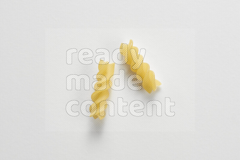 Fusilli pasta on white background