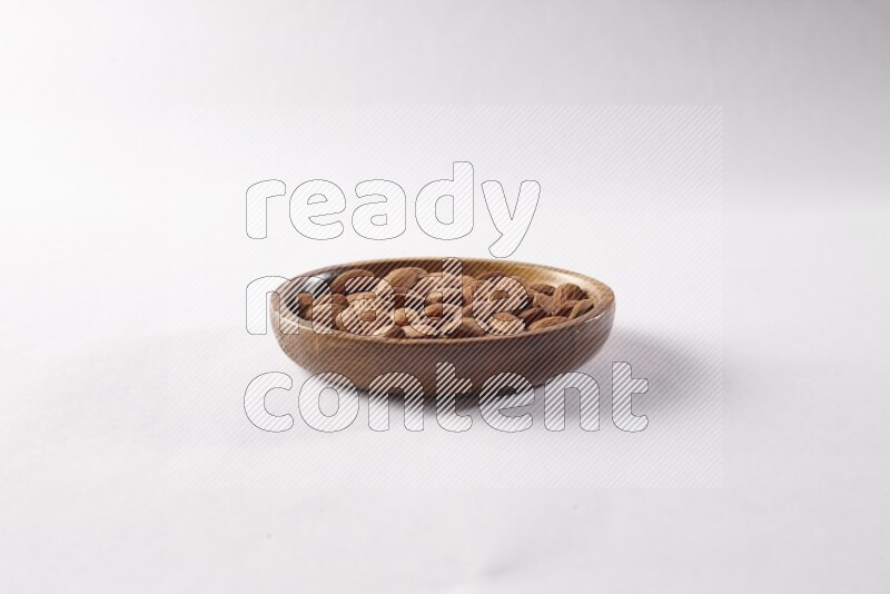 Almonds in a wooden bowl on white background