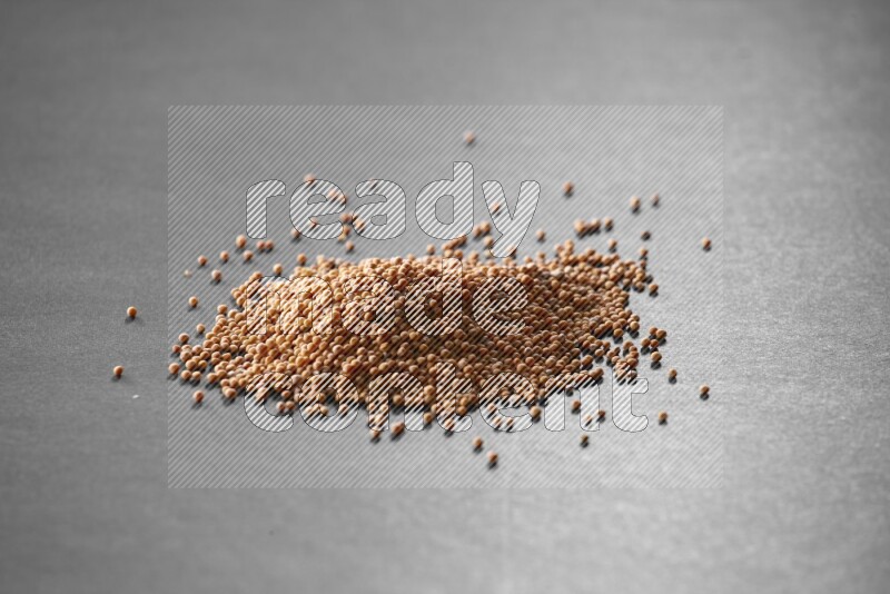 Mustard seeds on a black flooring