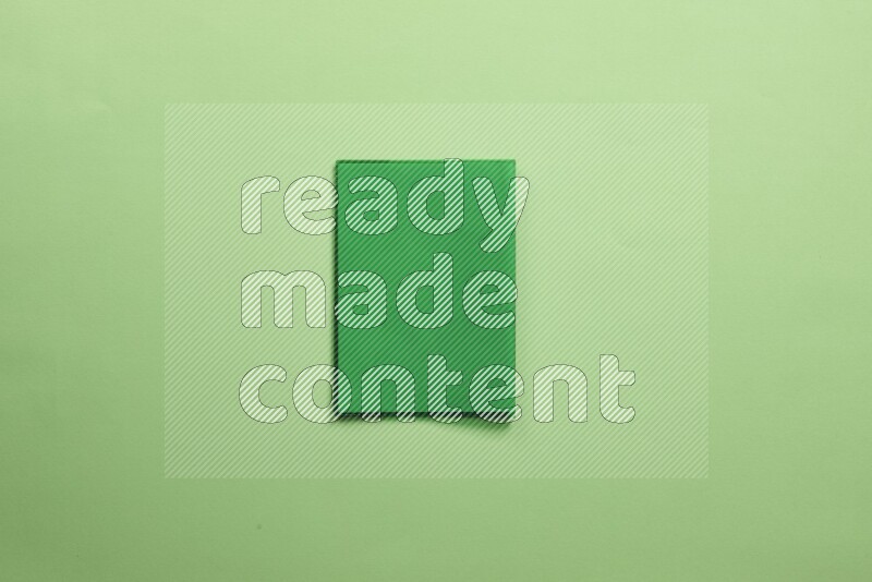 Multicolored notebooks on green background