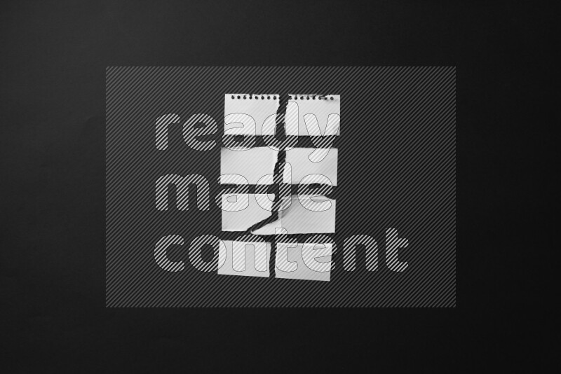 Ripped notebook sheet on black background