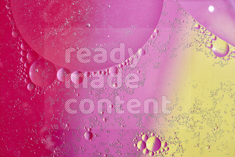 Close-ups of abstract oil bubbles on water surface in shades of yellow and pink