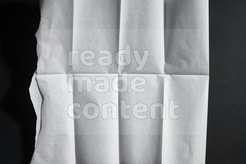 White paper sheet on black background