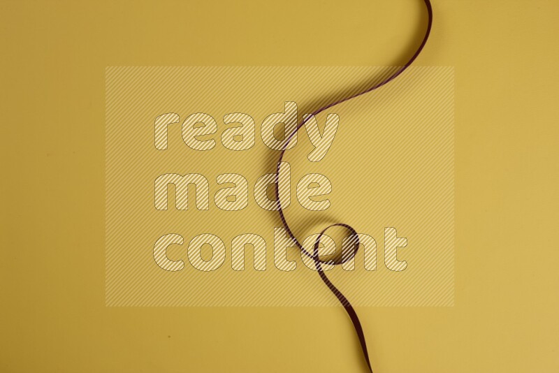 A red collection of sewing and tailoring tools arranged on a yellow background